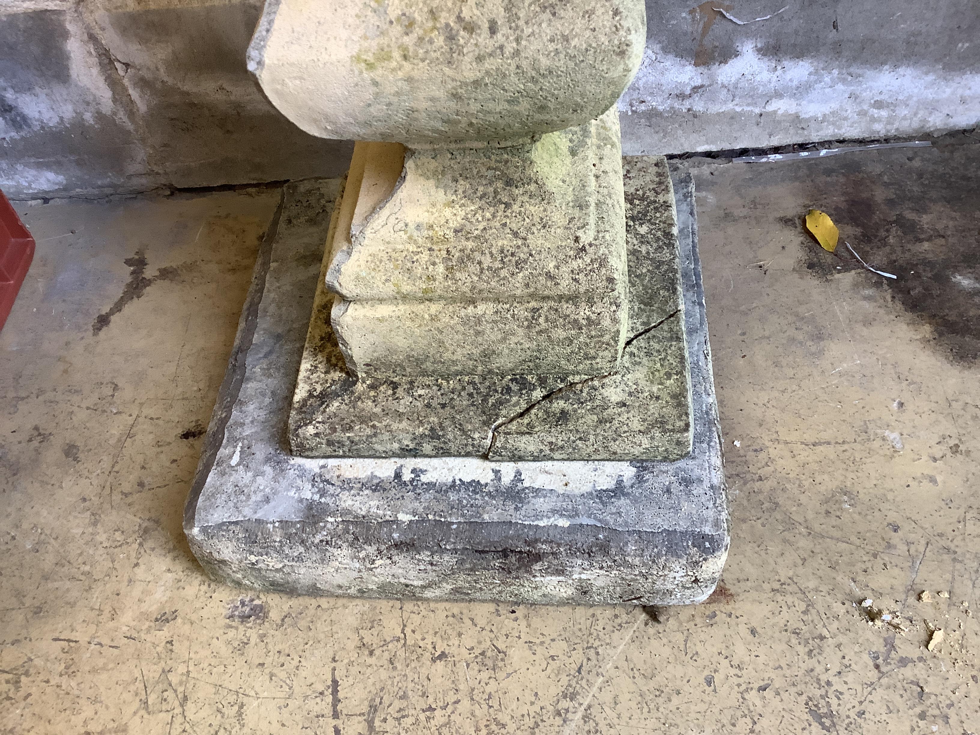 A circular stone bird bath on square plinth, diameter 58cm, height 95cm.